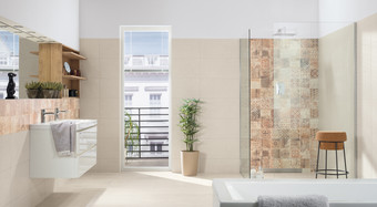 RAKO | Koupelna ve světle béžové barvě s imitací betonu. Doplněná o obklady v hnědé barvě s patchworkovým motivem.