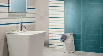 RAKO | Koupelna z obkladů v béžové a modré barvě. Dekor v bílé barvě s pruhy. Na zemi dlažba v béžové barvě.
