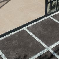 RAKO | Terasa nakombinovaná z černé a béžové barvy s imitací teraco. Pokládka na terče i do štěrku.