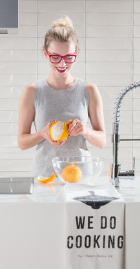 RAKO | Kromě slečny loupající pomeranč jsou zde vidět bílé obklady s reliéfem a vysokým leskem ve tvaru lícové cihly.